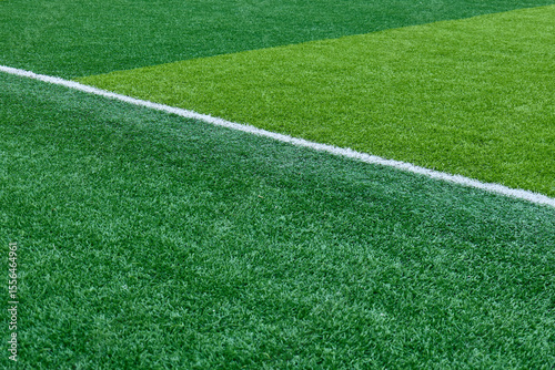Close up of bright green artificial turf and crisp white markings