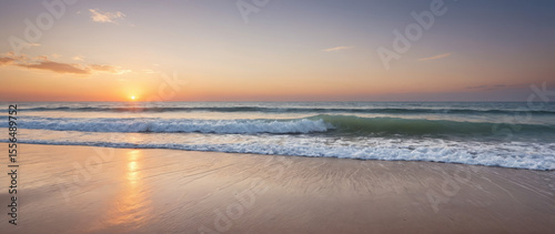 Serene Wide Shot of an Empty Beach at Sunrise with Pastel Sky and Gentle Waves for Wellness Retreats and Travel Destination Advertising