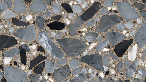Close up of a terrazzo surface with gray white and black stones in a gray matrix