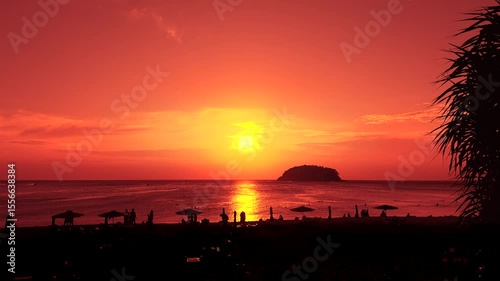 People enjoy tropical island beach during sunset in Krabi, Thailand