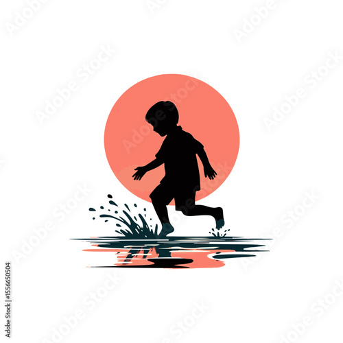 A playful boy splashing in a puddle