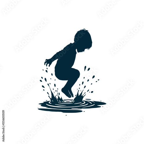 A playful boy splashing in a puddle