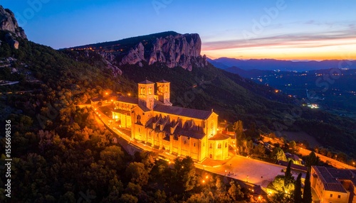Stunning church nestled in mountains captured from a high angle with dramatic scenery