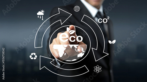 Conceptual representation of environmental sustainability with eco symbols, recycling icons, and a businessman interacting with digital graphics for green technology