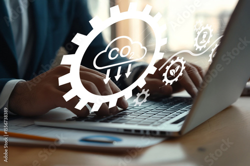 Business Person Using Laptop with Cloud Computing Concept and Eco-Friendly Elements Representing Carbon Emission Reduction Strategy in Modern Workspace