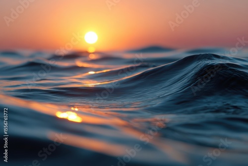 Fototapeta Naklejka Na Ścianę i Meble -  Sunset reflecting over gentle ocean waves, relaxing evening at sea