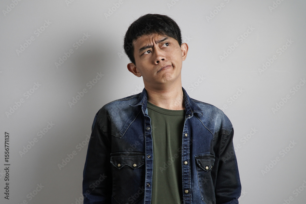 Fototapeta premium a confused young Asian man