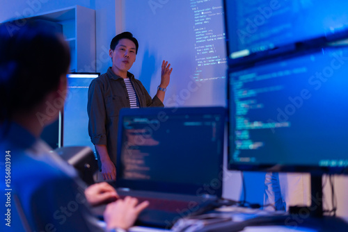 Canvastavla Asian software engineer or programmer team working late in development office,problem solving or algorithm of ai assistant helping for work