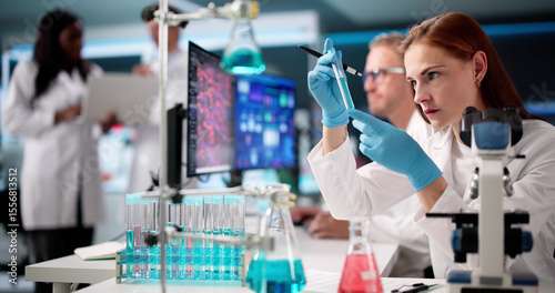 Multiracial Doctors In Laboratory Analyzing Data
