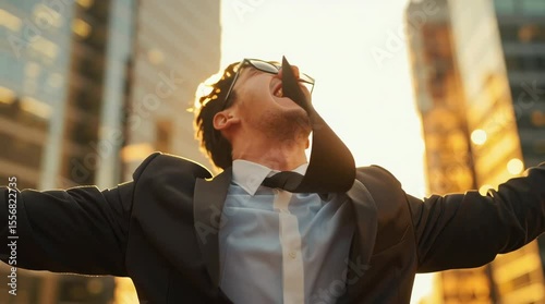 A joyful businessman celebrating success in the city.