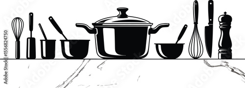 Black and white kitchen utensils arranged on a marble countertop