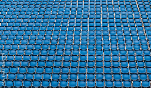 multiple row of blue reserved empty chair, seat in stadium for soccer, football sport game and festival or concert in lined up in a row for audience