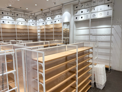 Bild auf Leinwand Retail store with fully installed empty white shelve racks and bright lighting b