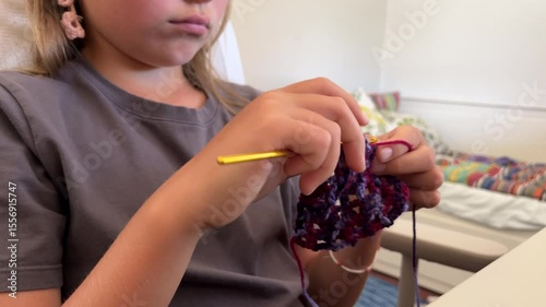 Girl crocheting at home in a cozy atmosphere