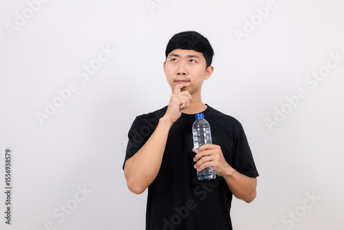 Positive asian man black shirt hold water bottle gesture thinking isolated