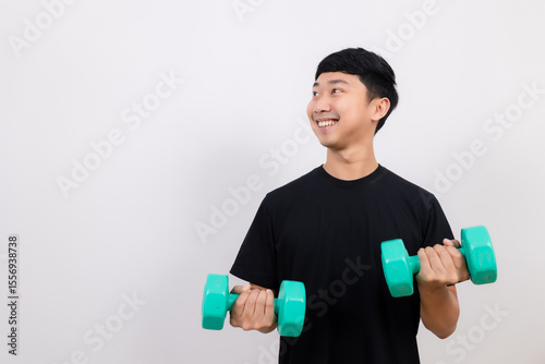 Positive asian man happy smile black shirt work out with dumbbell smile and look at space isolated