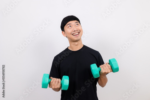 Positive asian man happy smile black shirt work out with dumbbell smile and look up at space isolated