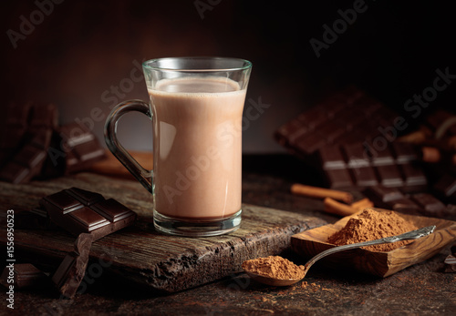 Creamy hot chocolate drink on a brown background.