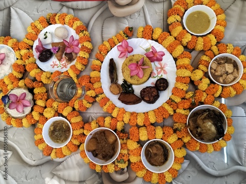 Hindu blessed food for God and rituals as per culture, offerings to the deity, or sacred food for grace or blessing in religious offering in Hinduism. Decorated with marigold flowers and garlands.