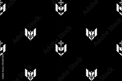 Clean seamless ethnic pattern featuring simple yet stylish white pixel motifs on a stark black background. Ideal for modern designs with a subtle cultural influence.Monochrome Minimalist Ethnic Pixel