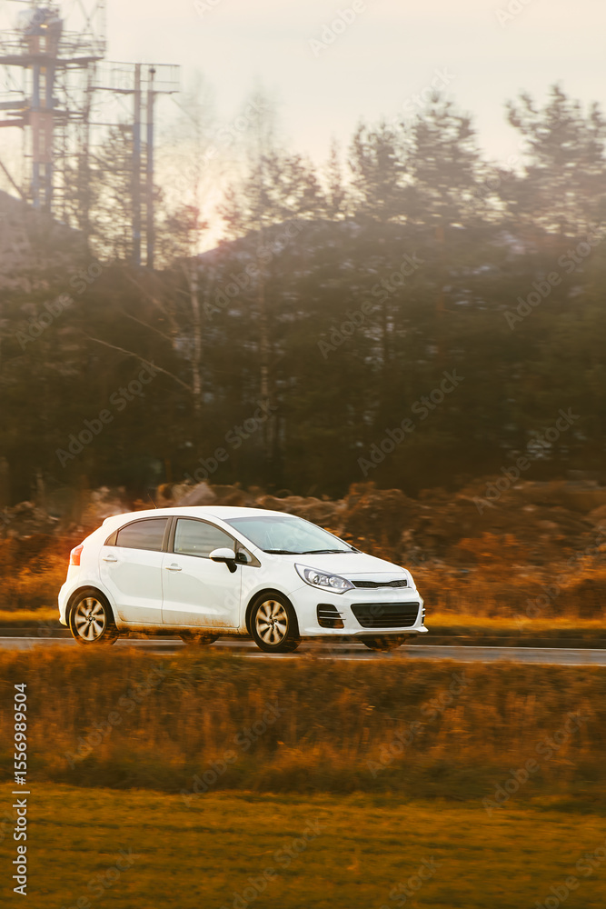 Small modern car traveling through urban area Small modern car traveling through urban area
