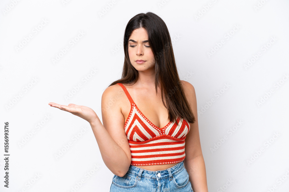 Fototapeta premium Young Brazilian woman isolated on white background holding copyspace with doubts