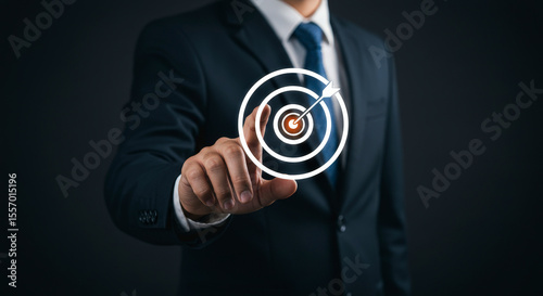 Businessman in Dark Suit Touching Digital Target with Arrow on Dark Background Promoting Business Goal Achievement