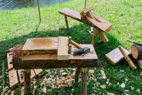 Handmade Wooden Bowl in Progress at Open-Air Workshop. Historical Woodcraft Scene with Primitive Tools.