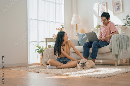 Asian family stay at home together with dog on holiday. Love couple lifestyle.