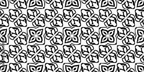 Geometric Floral Pattern: An elegant pattern featuring a symmetrical arrangement of stylized floral motifs, forming an intricate and visually appealing repeating design. 