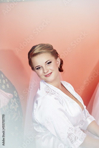 A woman in a white robe is smiling for the camera