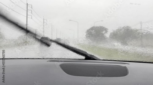 Driving car through the road with heavy rainy day