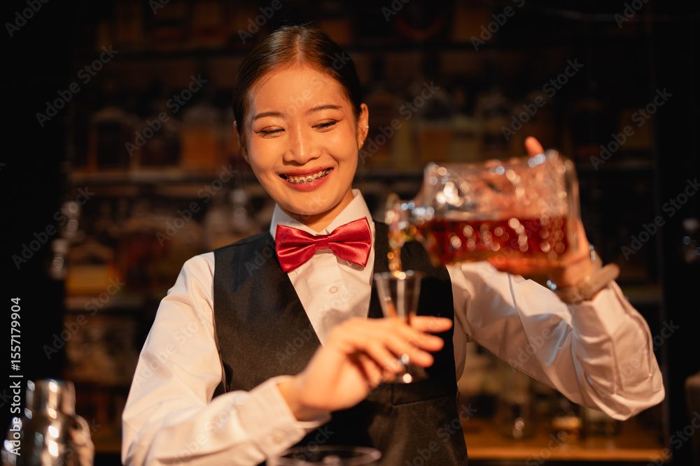 Professional female bartender preparing alcoholic drinks in a bar Professional female bartender preparing alcoholic drinks in a bar