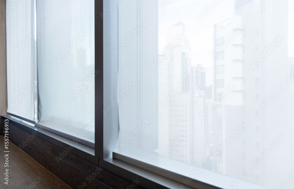 Fototapeta premium Motorized roller blind on big window
