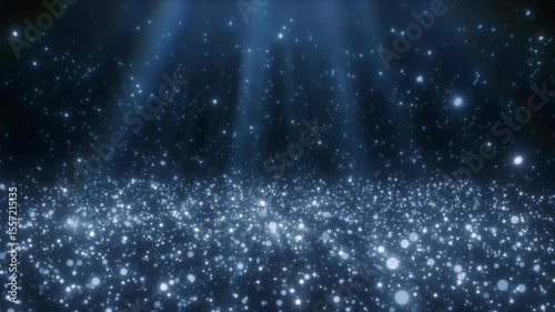 Shimmering blue particles creating a sparkling floor with gentle light rays shining from above. Perfect for magical, elegant, festive, or fantasy-themed backgrounds and motion graphics.