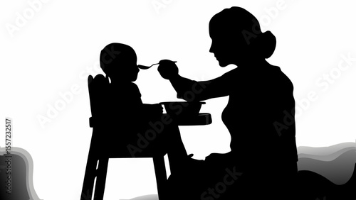 Silhouette of mother feeding baby in high chair with spoon and bowl in a black and white setting