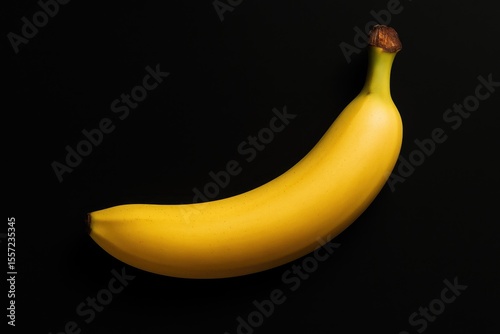 A yellow fruit against a dark backdrop
