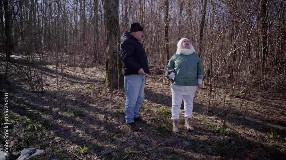 elderly couple enjoys a peaceful walk in the forest, holding hands and smiling. Authentic, unposed moment of love and connection in nature. Perfect for lifestyle, wellness, and aging-related content elderly couple enjoys a peaceful walk in the forest, holding hands and smiling. Authentic, unposed moment of love and connection in nature. Perfect for lifestyle, wellness, and aging-related content