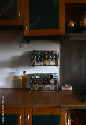 natural looking kitchen counter with copyspace, spice rack and olive oil