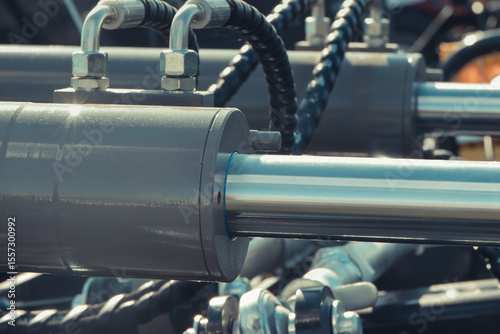Gray piston or actuator in black pneumatic or hydraulic machine. Technology