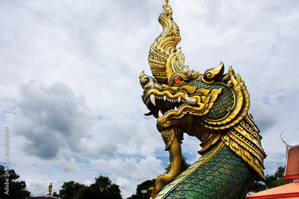 Fototapeta premium Ancient art of naga or antique naka statue of Wat Phra Kaew temple for thai people travelers travel visit and respect praying and blessing holy mystery worship at Chainat city in Chai Nat, Thailand