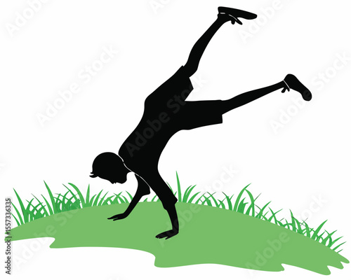 Silhouette of a person doing a cartwheel on a green grass patch