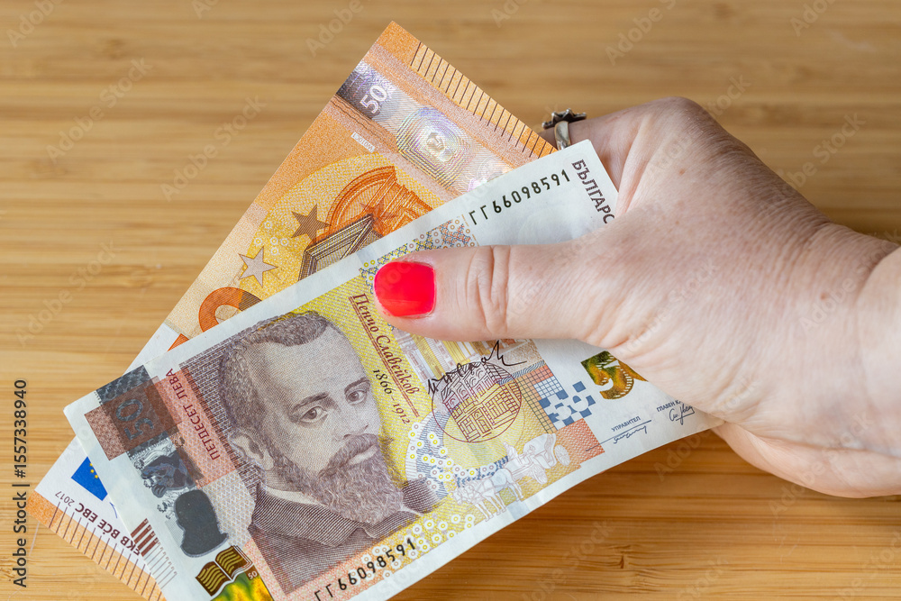 custom made wallpaper toronto digitaleuro and Bulgarian money. A woman's hand squeezes a 50 leva and 50 euro banknote. Bulgaria's adoption of the euro. Doubts for and against joining the eurozone