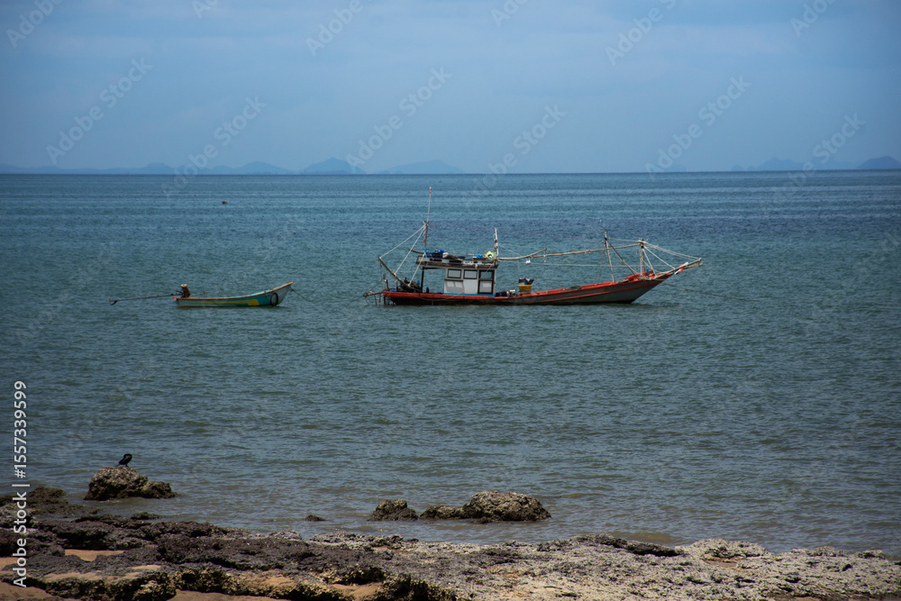 Thai local wooden small fishing boat float in sea ocean at Sairee sand beach in Gulf of Thailand and wait catch fish and marine life in night time in Chum phon city in Chumphon province of Thailand Thai local wooden small fishing boat float in sea ocean at Sairee sand beach in Gulf of Thailand and wait catch fish and marine life in night time in Chum phon city in Chumphon province of Thailand
