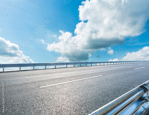 Asphalt highway road and beautiful sky clouds under blue sky