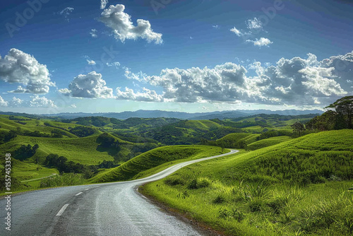 Peaceful Winding Road in Scenic Countryside Landscape with Blue Sky

