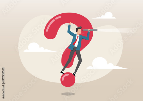 A businessman in a suit standing and balancing atop a large, red question mark