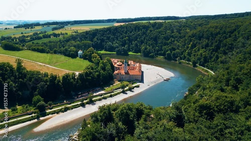 Kloster Weltenburg on the Danube River, Germany, shot from a drone in summer. Historic Benedictine monastery surrounded by forested cliffs and dramatic river curves near Kelheim