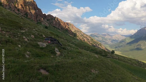 Six aerial views of a dark suv parked on the side of a lush green mountain, offering diverse perspectives of the vehicle against the backdrop of the natural landscape
