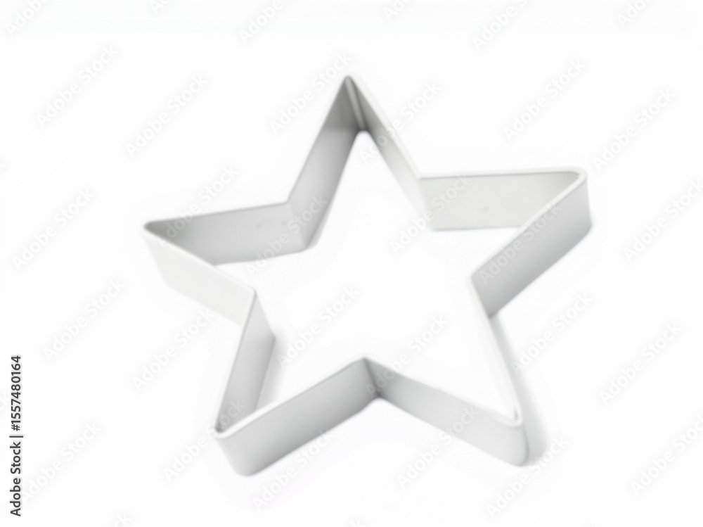 Obraz premium Star-shaped cookie cutter for baking in stainless steel material isolated white background